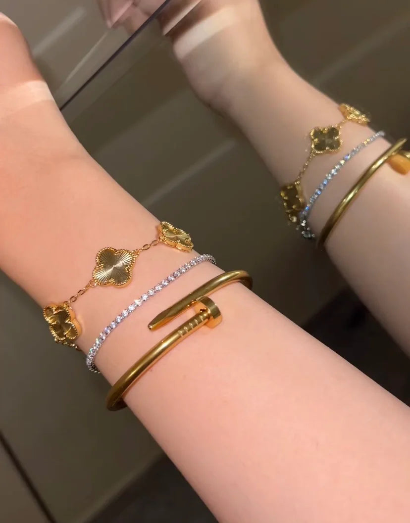 Cartier nail with golden clover & silver tennis bracelet